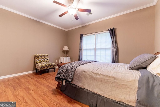 bedroom featuring ceiling fan, light hardwood / wood-style floors, and crown molding