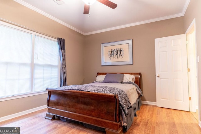 bedroom featuring ceiling fan, light hardwood / wood-style floors, and crown molding