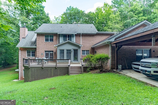 back of house featuring a yard and a wooden deck