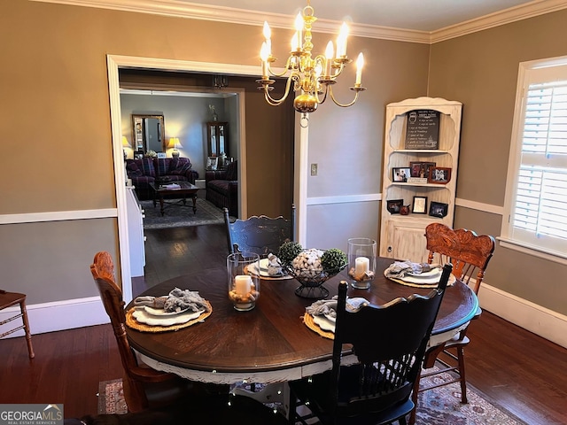 dining area with an inviting chandelier, crown molding, and dark wood-type flooring