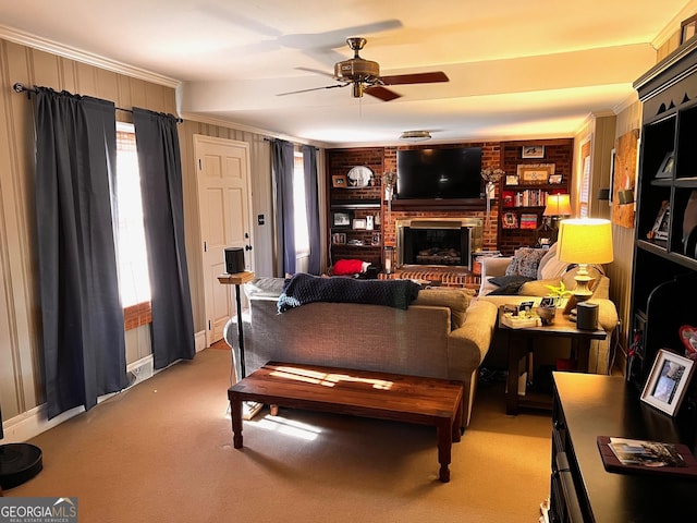 314 Cherokee Rd, Thomaston, GA 30286 - living area featuring ceiling fan, built in shelves, a brick fireplace, ornamental molding, and light carpet