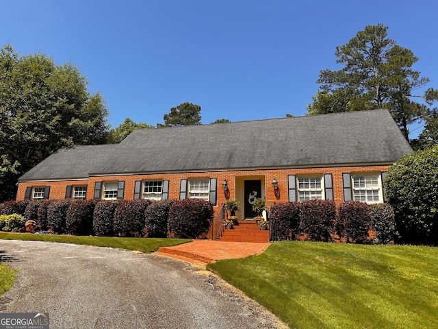 314 Cherokee Rd, Thomaston, GA 30286 - cape cod home featuring brick siding, a front lawn, and roof with shingles