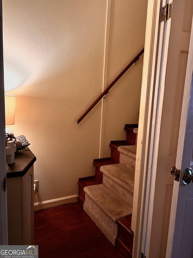 staircase with hardwood / wood-style floors