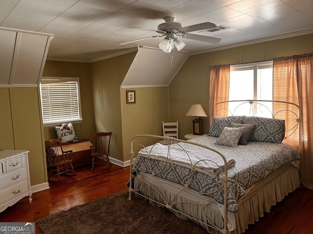 bedroom with crown molding, lofted ceiling, dark hardwood / wood-style floors, and ceiling fan