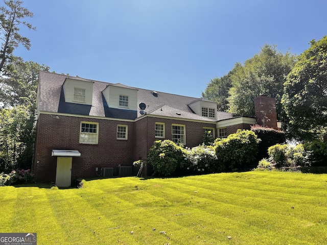 314 Cherokee Rd, Thomaston, GA 30286 - rear view of property with a lawn, brick siding, central AC unit, and a chimney