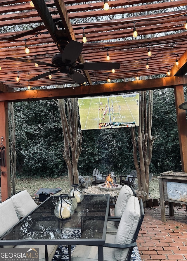 view of patio with ceiling fan, an outdoor fire pit, and a pergola