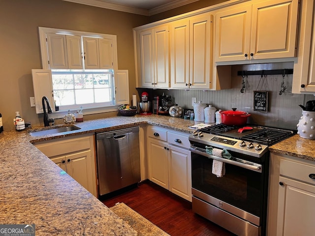 kitchen with dark hardwood / wood-style floors, white cabinetry, sink, stainless steel appliances, and crown molding