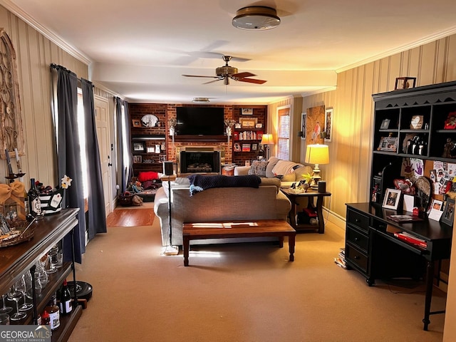 carpeted living room with crown molding, ceiling fan, and a fireplace