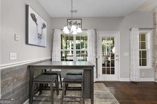 dining room featuring a notable chandelier and dark wood-type flooring