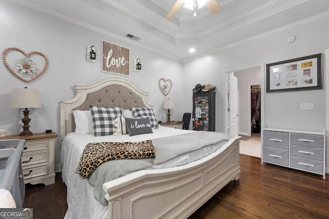 bedroom featuring ceiling fan, a raised ceiling, crown molding, and dark hardwood / wood-style floors