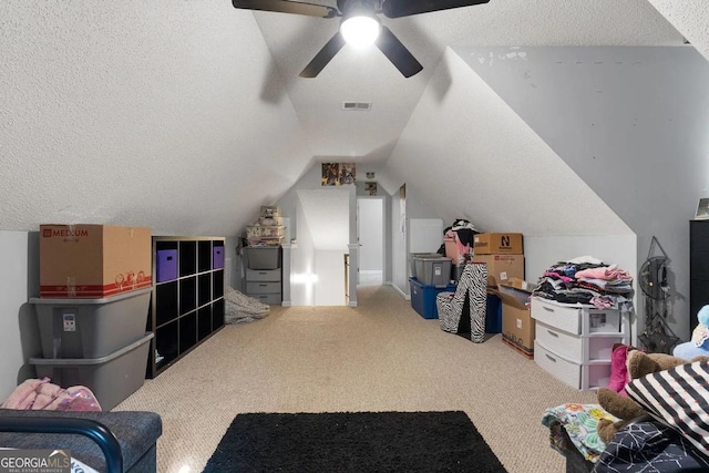 additional living space featuring carpet flooring, a textured ceiling, ceiling fan, and vaulted ceiling