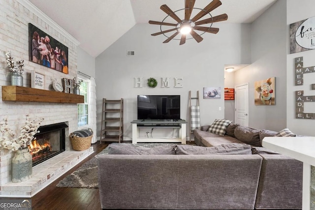 living room with lofted ceiling, hardwood / wood-style floors, a fireplace, and ceiling fan