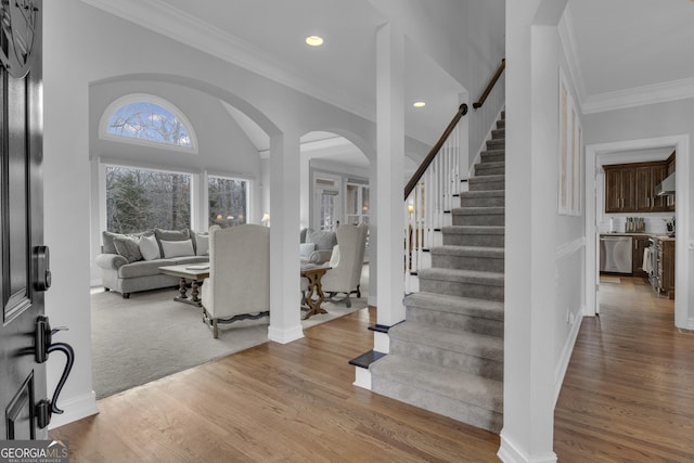 foyer featuring light hardwood / wood-style floors and crown molding