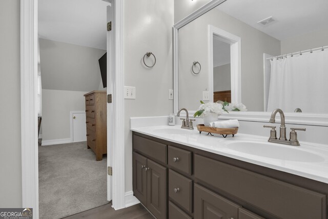 bathroom featuring toilet, vanity, tile patterned flooring, and tiled tub