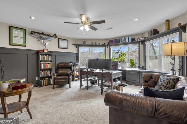 carpeted home office with ceiling fan