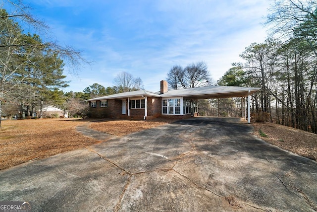 single story home featuring a carport