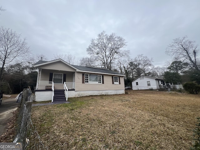 view of front of house with a porch and a front yard