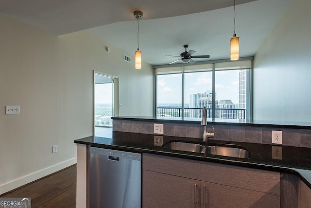 kitchen featuring decorative light fixtures, sink, dark hardwood / wood-style flooring, stainless steel dishwasher, and a healthy amount of sunlight