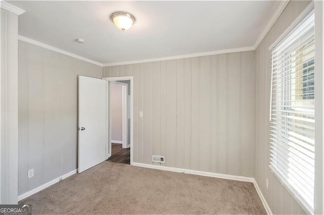 carpeted spare room with crown molding