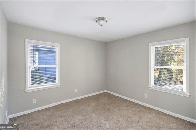 unfurnished room with light colored carpet