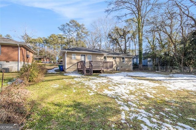 back of house featuring a deck and a yard