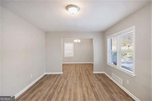 spare room with dark hardwood / wood-style flooring