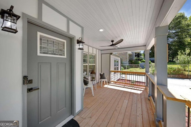 deck with covered porch and ceiling fan