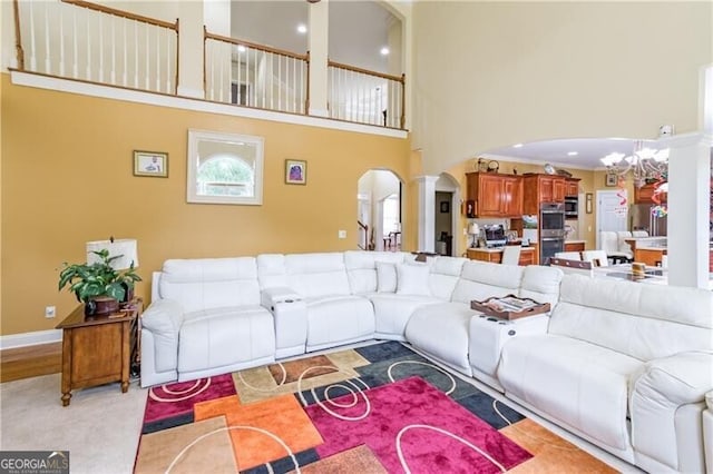 2080 Misty Oaks Dr, Buford, GA 30519 - living room featuring arched walkways, a chandelier, and a high ceiling