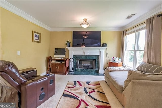 living room with a high end fireplace, crown molding, and carpet