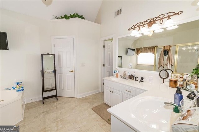 bathroom featuring an enclosed shower, lofted ceiling, and vanity