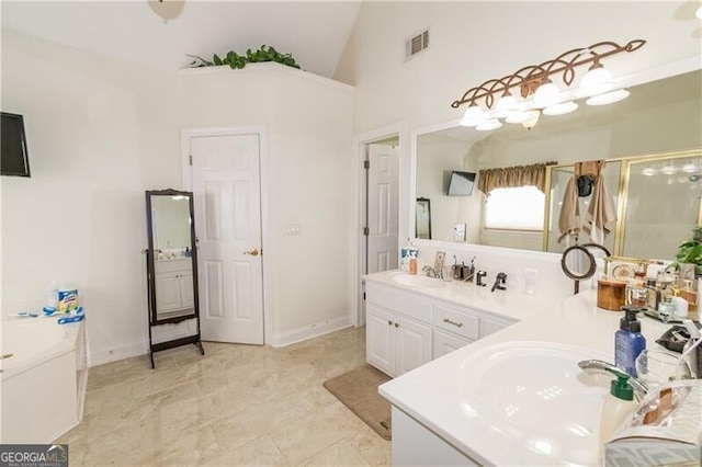2080 Misty Oaks Dr, Buford, GA 30519 - full bathroom featuring a stall shower, double vanity, a garden tub, high vaulted ceiling, and baseboards
