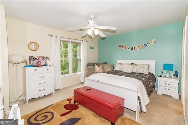 bedroom with ceiling fan and light colored carpet