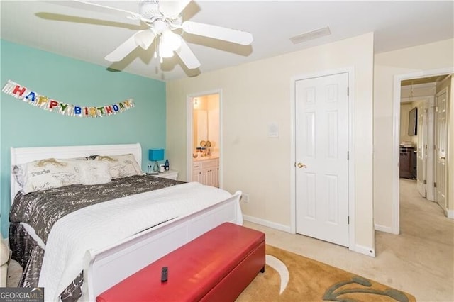 bedroom featuring ensuite bath, ceiling fan, and carpet flooring