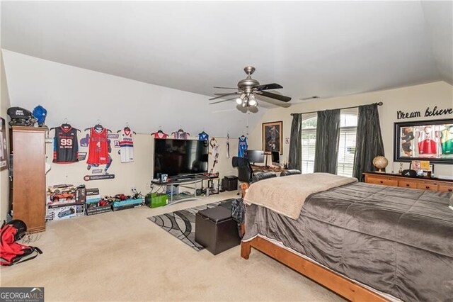 carpeted bedroom featuring lofted ceiling and ceiling fan