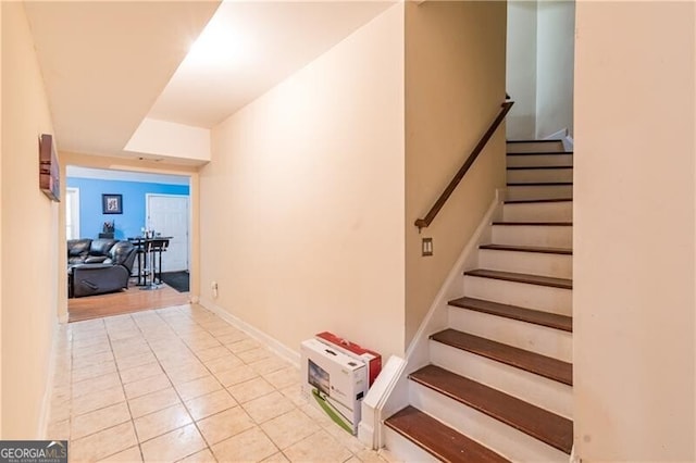 stairs featuring tile patterned flooring