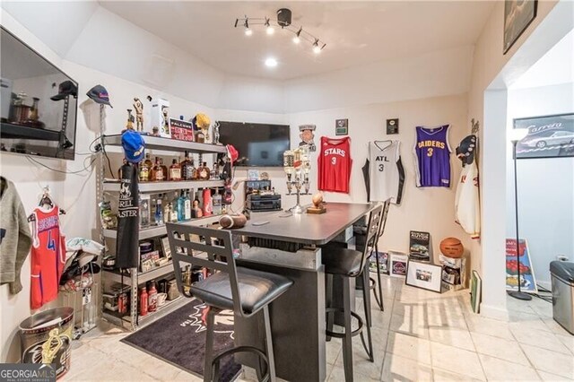 kitchen featuring a breakfast bar area and light tile patterned floors