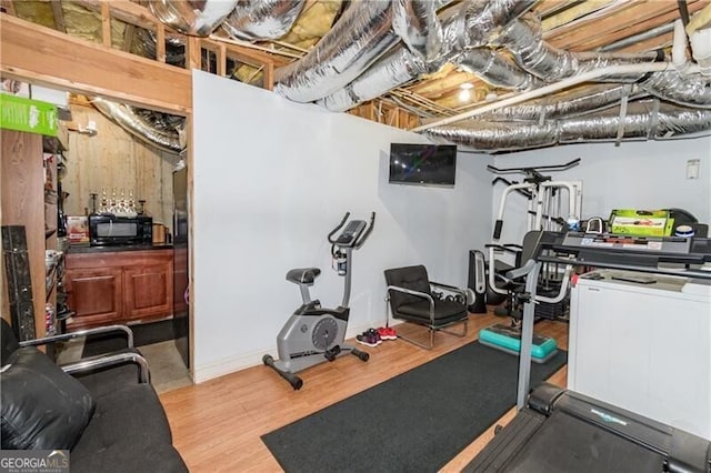 workout area featuring light hardwood / wood-style floors