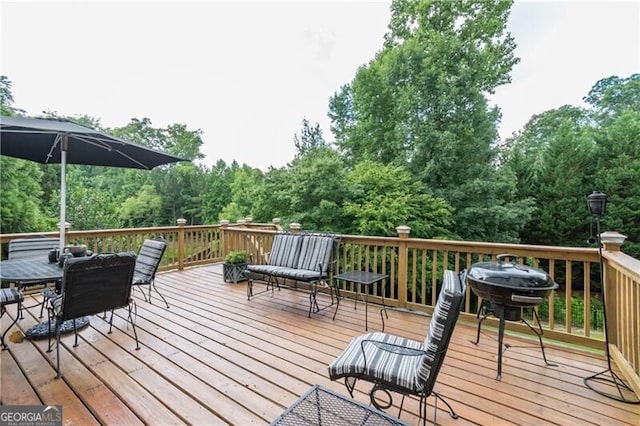 wooden deck with a grill