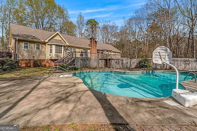 view of swimming pool with a deck and a patio area