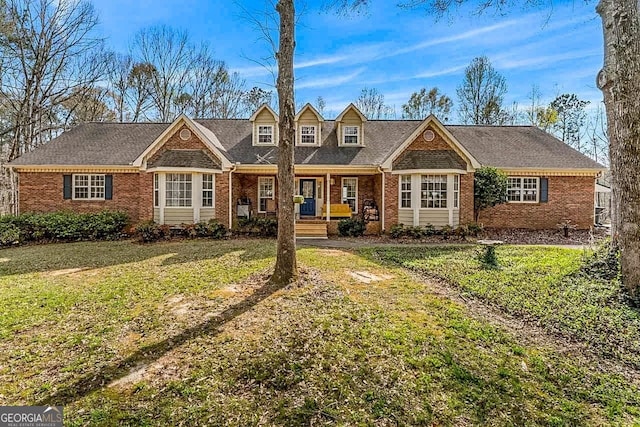 view of front of home with a porch and a front lawn