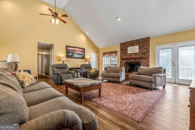 living room with ceiling fan, french doors, a textured ceiling, and wood-type flooring