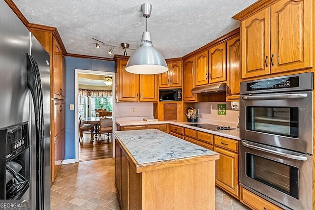 kitchen with a textured ceiling, pendant lighting, a kitchen island, black appliances, and crown molding