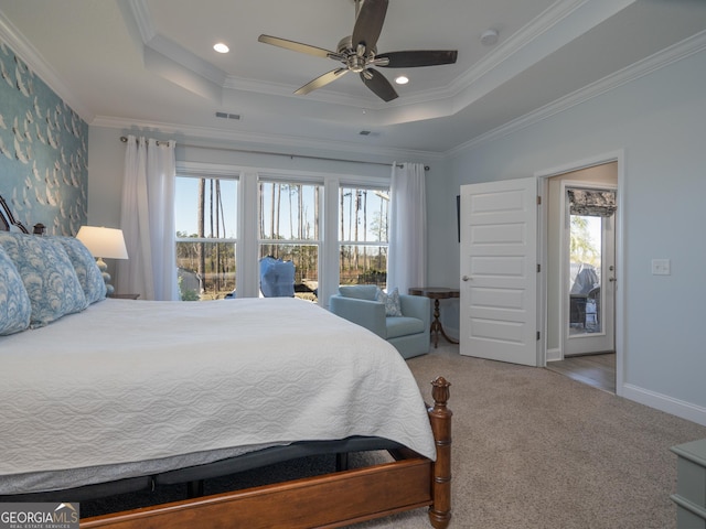 bedroom featuring ceiling fan, crown molding, a raised ceiling, and carpet floors