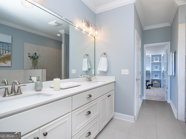 bathroom featuring tile patterned floors, crown molding, and vanity