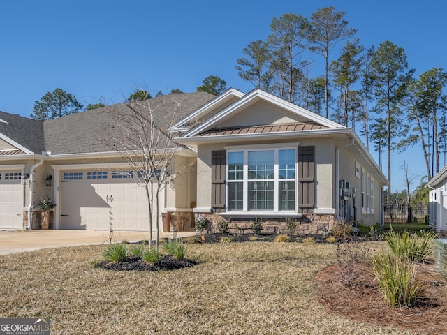 view of front of home featuring stone siding, stucco siding, an attached garage, and concrete driveway