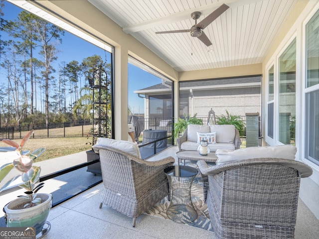 sunroom featuring ceiling fan