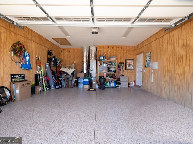 131 Ryan Nicholas Dr, Kingsland, GA 31548 - garage featuring a garage door opener and wood walls