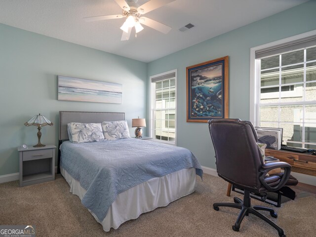 bedroom featuring light colored carpet and ceiling fan