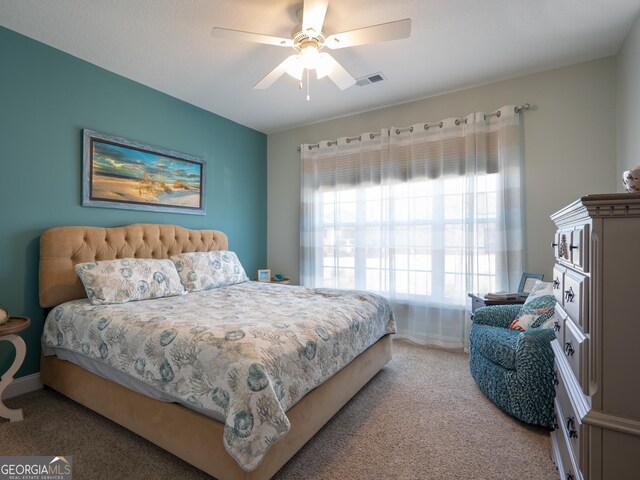 bedroom featuring ceiling fan and carpet flooring