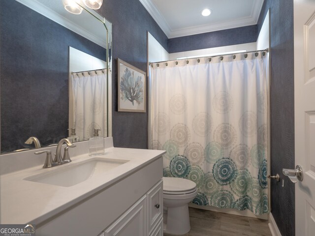 bathroom featuring hardwood / wood-style floors, toilet, crown molding, vanity, and curtained shower